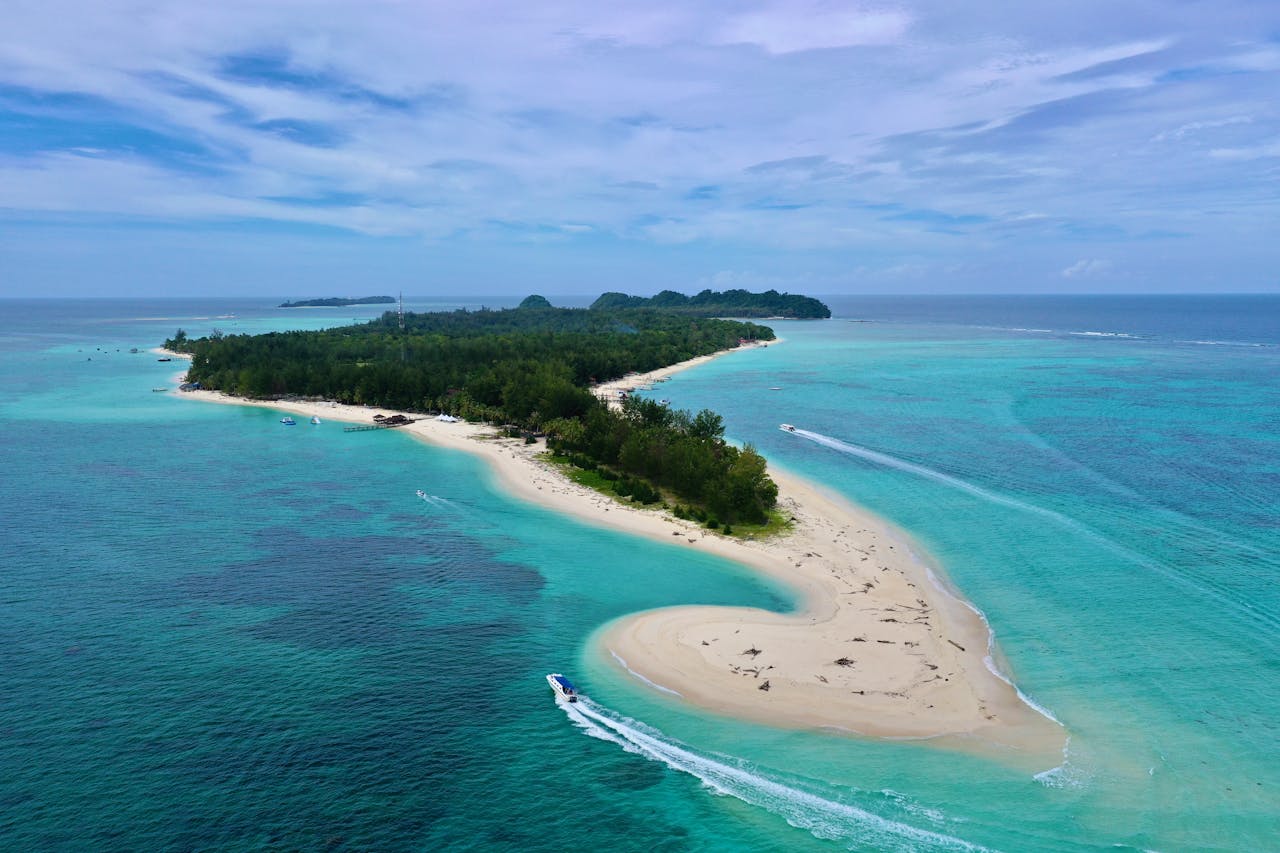 Stunning aerial view of Pulau Mantanani, Malaysia's turquoise waters and sandy beach.